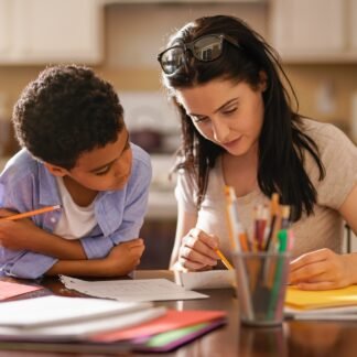 Woman Assisting Son In Doing Homework